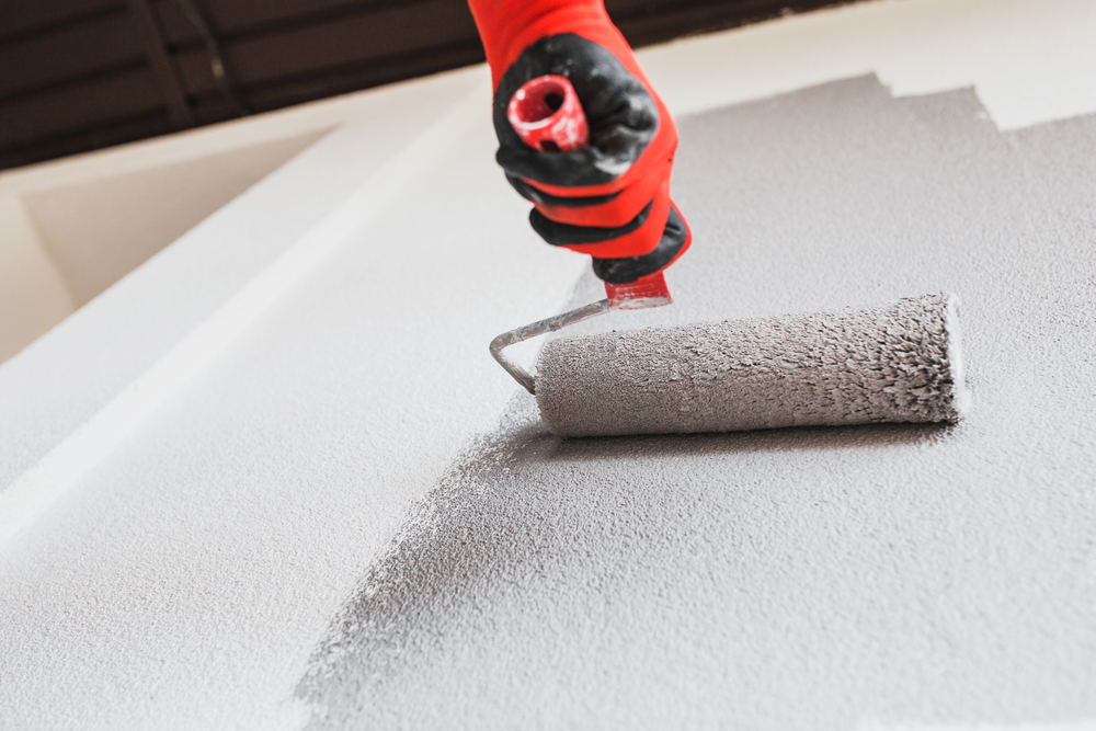 Renovation painter rolling a fresh coating over a prepared surface in Newcastle