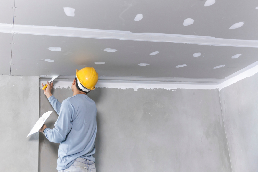 Tradesperson setting plasterboard joints and screw holes on a Port Stephens interior fit-out