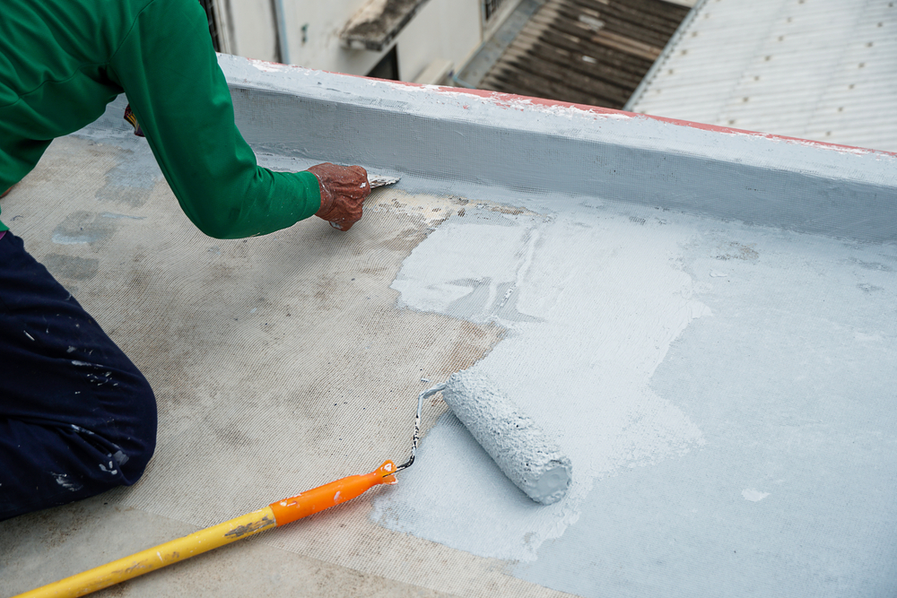 Tradesperson patching and coating a rendered surface ready for paint in Lake Macquarie