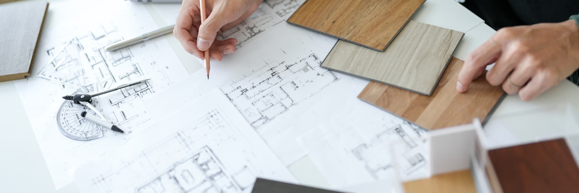Plans, timber finish samples and drafting tools laid out while planning an interior decorating project in Maitland